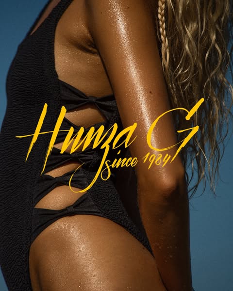 This ad features a close-up shot of a woman wearing a black Hunza G swimsuit. The brand logo is prominently displayed ov