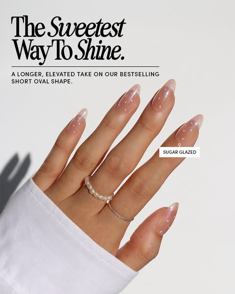 This ad showcases a hand wearing press-on nails with a white polka dot design. The ad highlights the shape and design of
