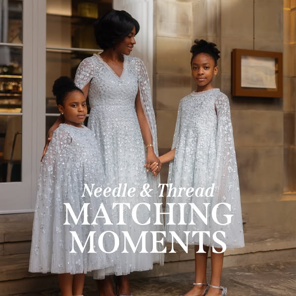 An elegant image ad featuring a Black mother and her two daughters, all wearing matching light blue, sparkly dresses wit