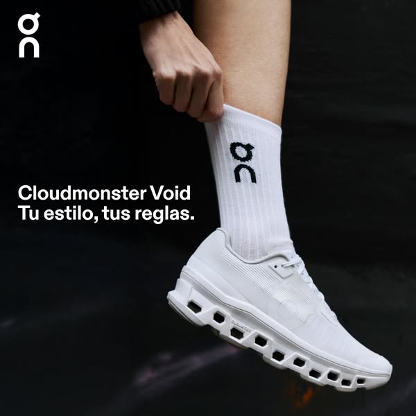 This ad showcases the On Cloudmonster Void running shoe in an all-white colorway. It features a hand adjusting a sock, a
