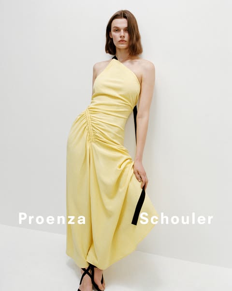 This image ad features a light yellow, one-shoulder dress from designer brand Proenza Schouler, presented against a whit
