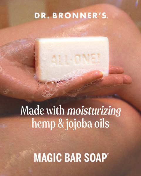 This ad features a close-up shot of a hand holding a bar of Dr. Bronner's soap, emphasizing its moisturizing propert