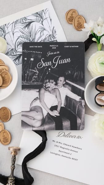 This ad features a flatlay product shot of a wedding invitation. The invitation is black and white and features a photo 