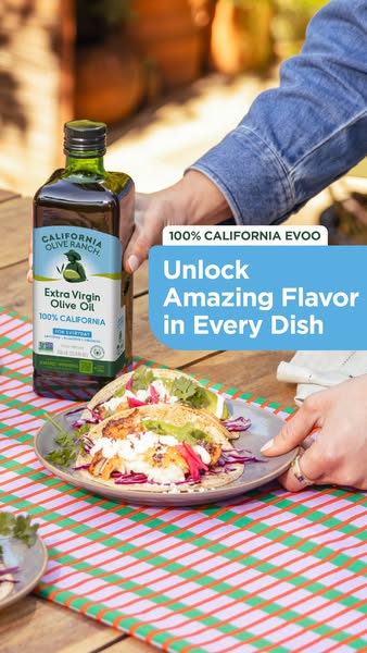 This ad promotes California Olive Ranch's 100% California Extra Virgin Olive Oil. It features a hand placing the oli