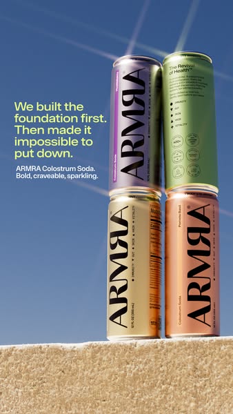 This ad features four cans of ARMRA Colostrum Soda stacked on top of each other, with the ad copy, "We built the fo