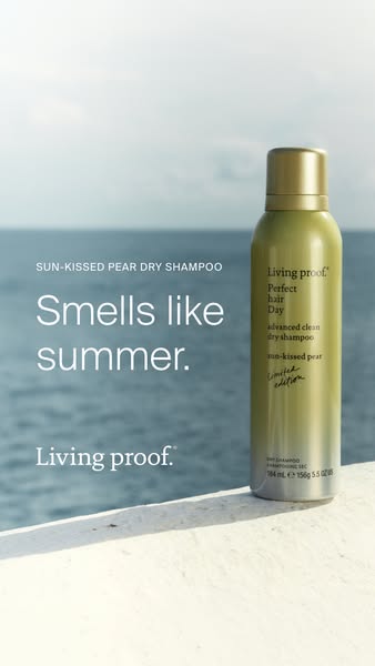 This Living Proof image ad showcases their Sun-Kissed Pear Dry Shampoo against an ocean backdrop, emphasizing a summer-l
