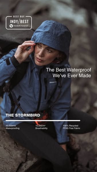 An ad featuring a person wearing a jacket with a hood up and sitting outdoors among rocks in the rain. Text highlights t
