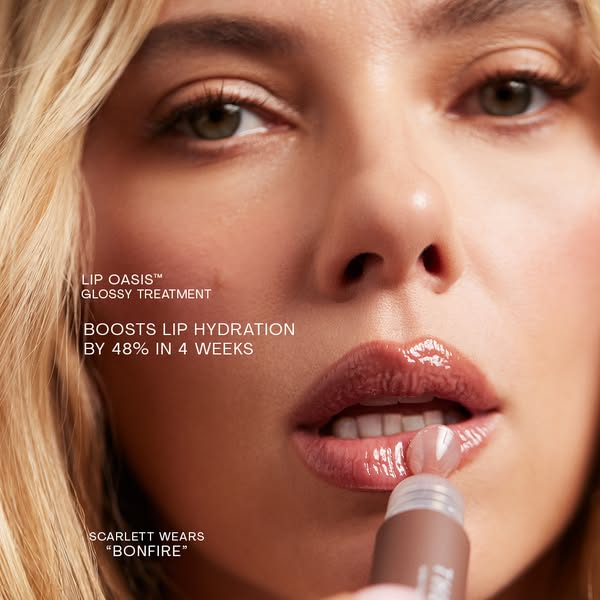 This ad showcases a close-up of a model applying a glossy lip treatment while calling out the product's hydrating be