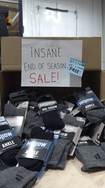 This ad shows a cardboard box full of HOJIOW brand socks with a handwritten sign taped to the box offering an "INSA