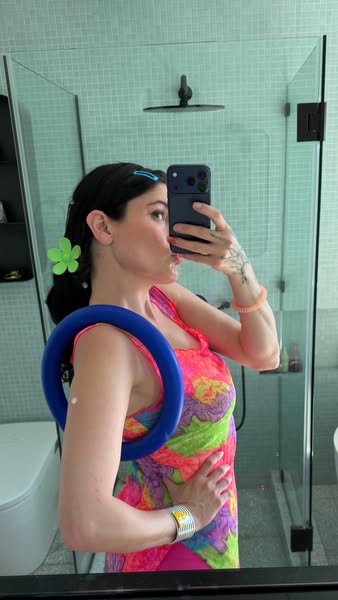 A selfie-style ad showcasing a woman with colorful accessories.