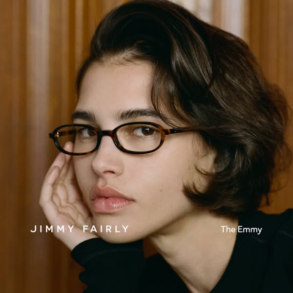 This Jimmy Fairly image ad showcases the 'The Emmy' glasses frame on a person. The ad highlights the eyewear bra
