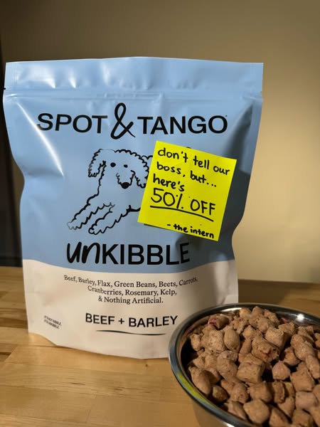 This ad for Spot & Tango Unkibble dog food features a bag of the product with a handwritten note advertising a 50% o