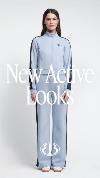 This ad showcases a woman modeling a blue track suit set. The ad focuses on new active looks.