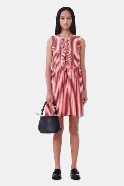 This ad features a model wearing a red and white striped dress and holding a black purse. The ad is a product showcase.