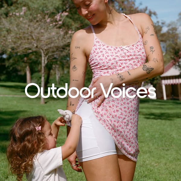 This ad features a photo of a woman and child outdoors, promoting a dress with built-in shorts from Outdoor Voices.