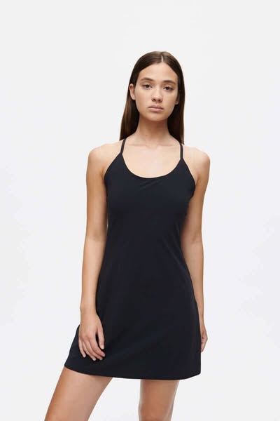 This ad features a woman wearing a black exercise dress against a white background.