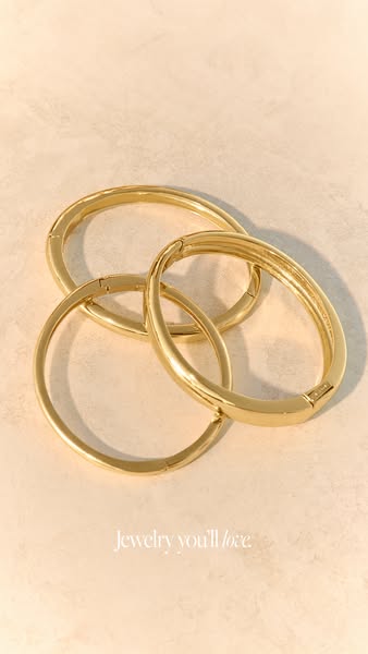 This image ad showcases gold bangle bracelets, conveying a message of understated elegance and timeless style. The headl