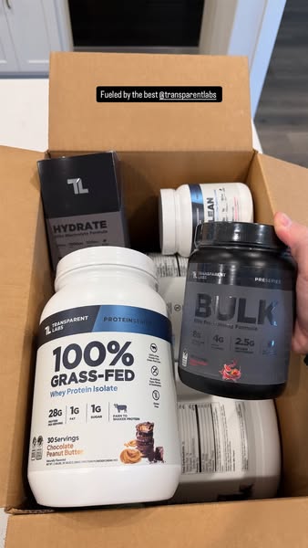 This ad showcases a variety of Transparent Labs supplements inside of a cardboard box. The products include protein powd
