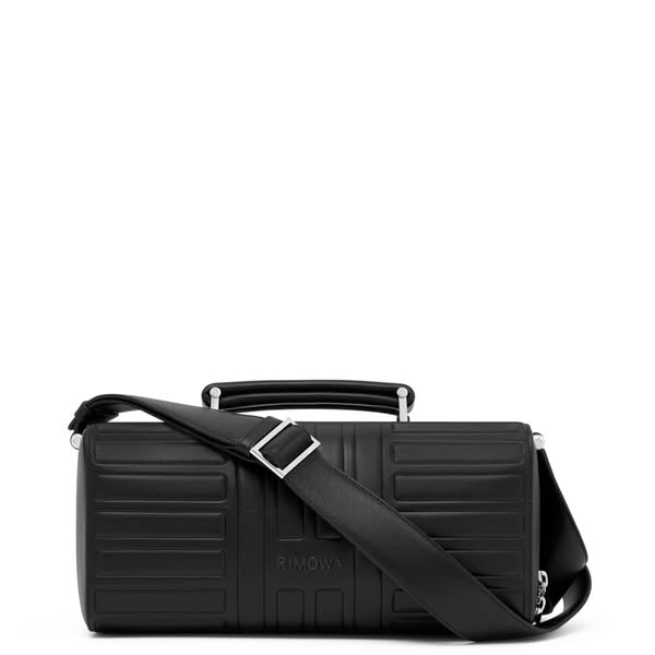 This ad features a black Rimowa bag with a shoulder strap on a white background.