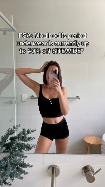 This ad features a woman in a bathroom mirror selfie, wearing Modibodi period underwear and a matching top. The ad highl