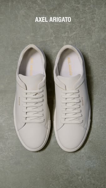 This ad showcases a pair of Axel Arigato sneakers in a minimalist style, emphasizing the brand's name and the produc