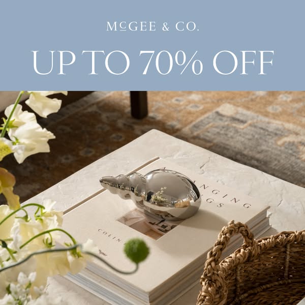 This ad from McGee & Co. features an image of a styled coffee table, with a ceramic shell perched on a stack of book