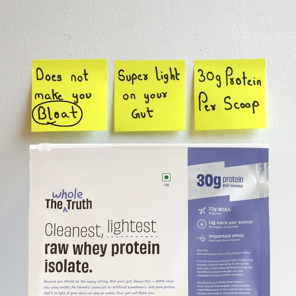 The Whole Truth static ad: handwritten yellow sticky notes above a tub of whey isolate, the top one reading "Does not make you bloat."