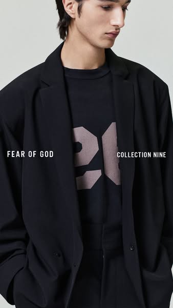 This image ad features a man wearing a dark colored blazer and t-shirt from Fear of God's Collection Nine. The image