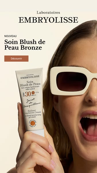 This image ad is for Embryolisse's Soin Blush de Peau Bronze. The ad features a model holding the product. The model