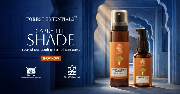Image ad for Forest Essentials sunscreen products, featuring two bottle sizes against a blue architectural backdrop.