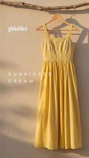 The image ad showcases Global Desi's 'Sunkissed Dream' dress. The ad uses soft lighting and neutral tones to