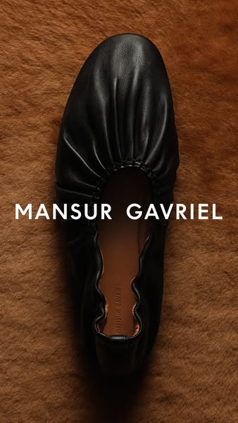 This is an image ad that showcases a black Mansur Gavriel ballet flat. The photo is a close-up shot of the shoe, highlig