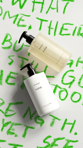 This ad showcases Byredo's Suede hand wash and lotion against an abstract green background, emphasizing the brand