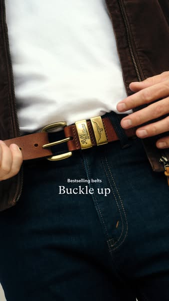 An image ad featuring a close-up of a person's torso wearing a leather belt, with the headline "Buckle up"