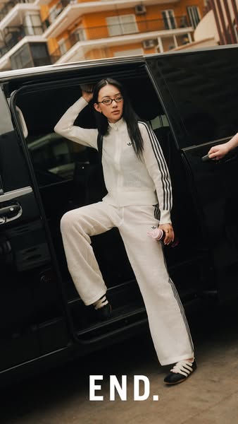 This ad features an image of a model exiting a black SUV wearing an Adidas tracksuit and sneakers. The brand's name 