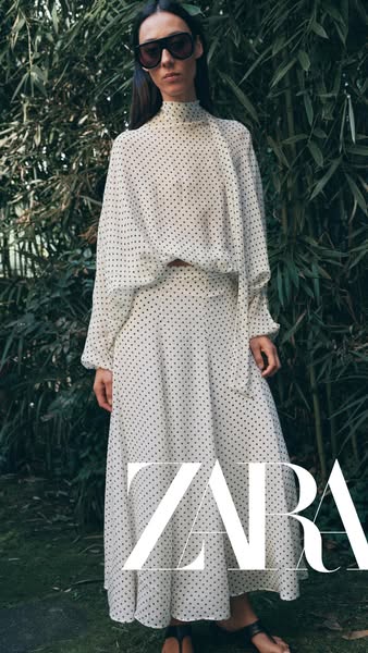 This ad features an image of a model wearing a matching two-piece set. The set is white with black polka dots. The brand