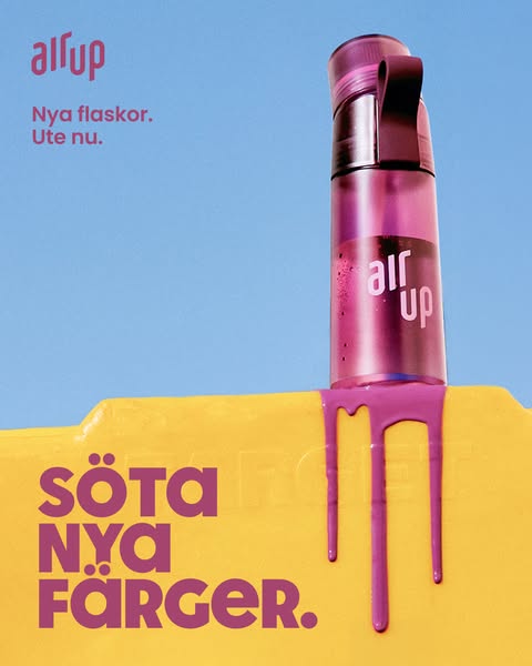 This ad shows a translucent purple Air Up water bottle, with a bright yellow platform that purple liquid is dripping dow