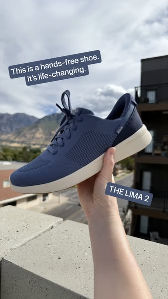 This image ad showcases a single blue shoe held up in front of an outdoor background. The shoe is advertised as a 'h