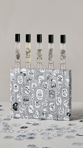This ad showcases a Diptyque fragrance set, featuring five different scents in small vials, presented in a decorative bo