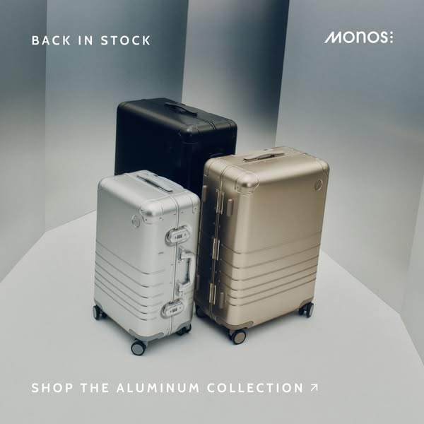 This image ad showcases three aluminum suitcases in different colors, promoting the 'Aluminum Collection' and hi