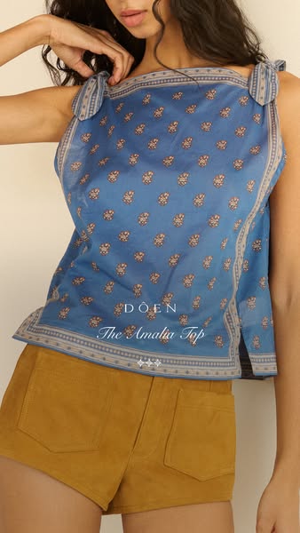 An ad for a floral patterned top from the brand DOEN.