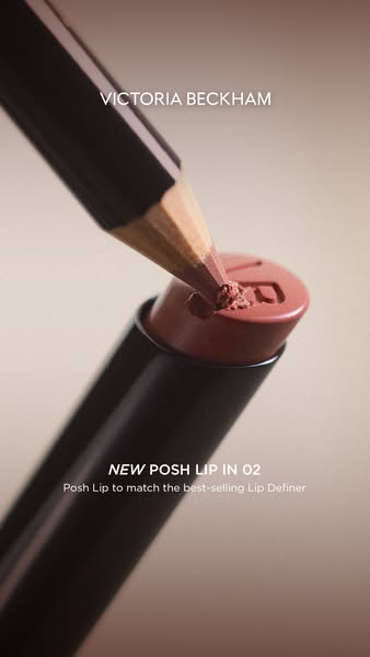 The image showcases the Victoria Beckham Beauty Posh Lip in 02 lipstick, emphasizing its compatibility with the brand