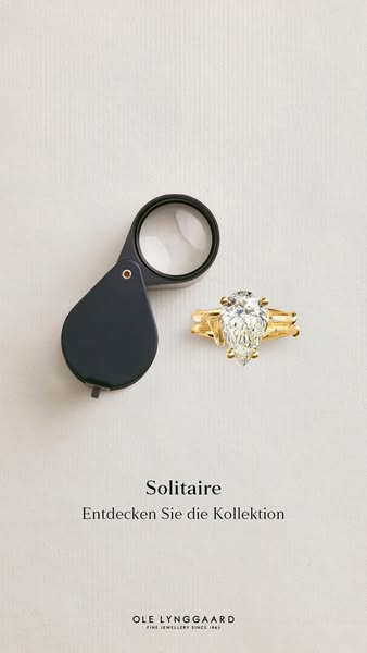 An image ad for Ole Lynggaard jewelry showcasing a close up shot of a solitaire ring with a large pear-shaped diamond on