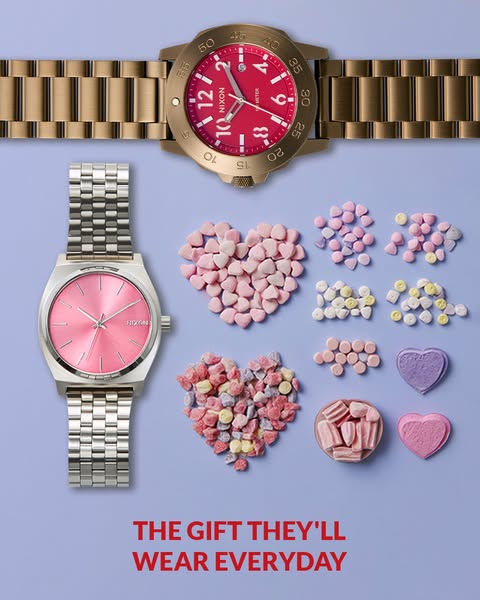 This image ad features two Nixon watches with a playful arrangement of heart-shaped candies around them. The ad is promo