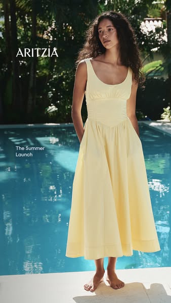 This image ad for Aritzia features a woman standing in front of a pool wearing a yellow dress. The ad highlights Aritzia