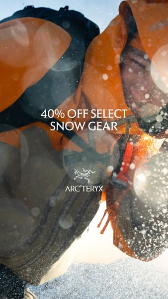 This Arc'teryx ad features a close up shot of a person wearing a jacket covered in snow with a flash of sunlight. Th