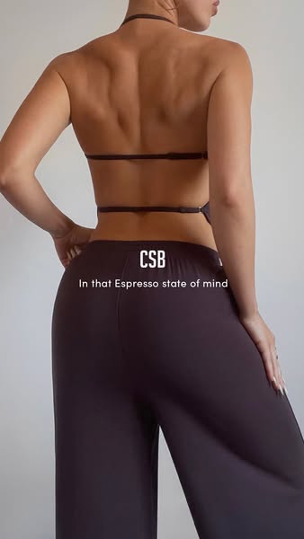 This image ad features a woman wearing a brown two-piece outfit. The ad highlights the brand's name and the phrase &