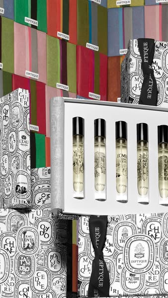This ad showcases the Diptyque fragrance set. It employs a visually rich presentation with various product placements an