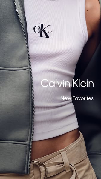 This image ad shows a model wearing a Calvin Klein tank top and skirt with a jacket partially in view, focusing on the b