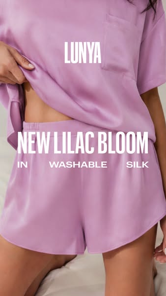 This ad showcases a lavender colored silk pajama set from Lunya. The ad highlights the material and color of the set.